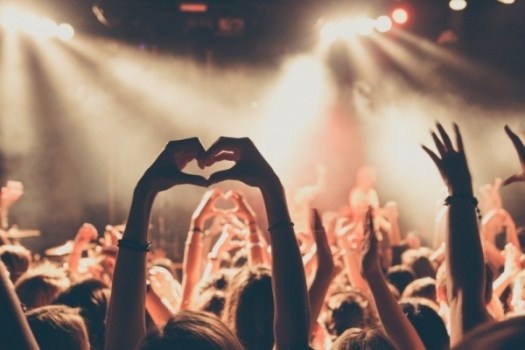 people-enjoying-rock-concert-with-heartshape-hand-gesture