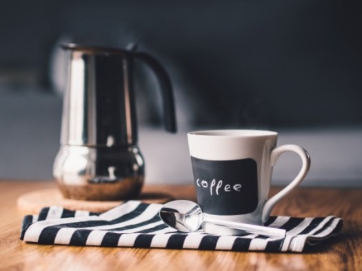 coffee-mug-and-coffee-percolator-on-table
